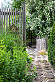 Fences made of old stakes as dividers in the garden