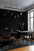 Dining room with black furniture and wall painted black
