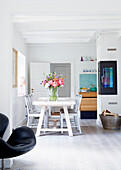 Dining area with lush bouquet of flowers in an open living space