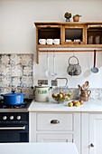 Kitchenette with antique cupboard and tiled backsplash