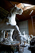 A plaster horse statue in a studio