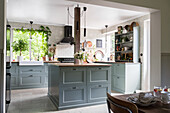 Country kitchen with a kitchen island in grey-green