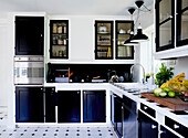 An L-shaped fitted kitchen with blue cupboard fronts