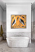 Antique marble bathtub, above it a work of art with a bird motif