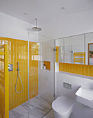 Shower area with yellow wall tiles in the bathroom