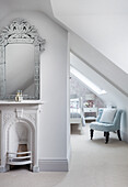 Mirror with decorative frame above fireplace niche