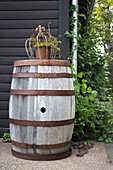 Weathered wooden barrel with rusty garden crown