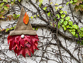 DIY gnome made of colorful leaves and burlap
