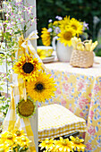 Sunflower heads with yellow ribbon as chair decoration