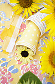 Craft supplies: Paper cups, fabric ribbons, flowers
