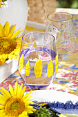 Glass decorated with individual sunflower petals