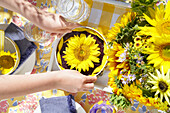 Sonnenblumenkuchen und Sonnenblumenstrauß auf Tisch im Freien