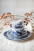 Porcelain cups and plates on embroidered tablecloths