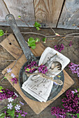 Napkin with cutlery and lilac flowers in vintage pan