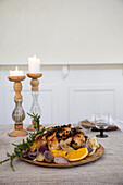 Festive table setting with roast chicken and candles