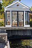Wooden cottage with glazing on the waterfront
