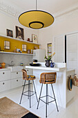 Bright kitchen with breakfast bar and vintage rattan bar stools