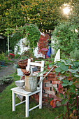 Decoration with old chair in an allotment garden with arbour in the background