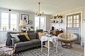 Cozy upholstered sofa, coffee table and armchair in a Scandinavian-style living room