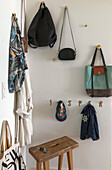 Bags and clothes on coat hooks