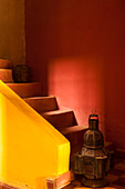 Morocco, an old lantern and jug on steps of a restored Kasbah with a texture overlay applied for a painterly look.