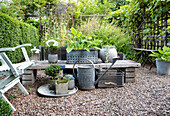 Table with plant pots on gravelled area