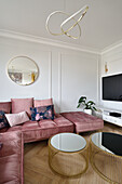 Comfortable pink velvet sofa with coffee table set in bright living room
