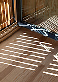 Light and shadow play of the sliding slats in front of the windows