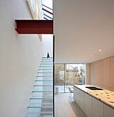Kitchen with access to courtyard and glass stairway