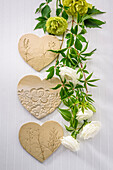 Table decoration, clay hearts and white roses