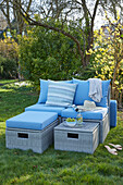 Cozy lounge furniture with blue cushions on the lawn