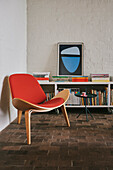 Vintage chair and side table in front of bookshelf