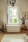 Free-standing bathtub with water pipe from the ceiling