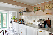 White kitchenette in a bright sunlit kitchen