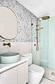 Modern bathroom in shades of white, grey and mint with gold fittings