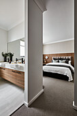 Modern bedroom in neutral tones with ensuite bathroom