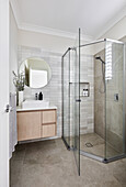 Modern bathroom in neutral tones with corner shower stall