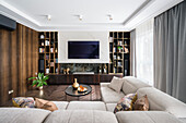 Hampton style living room, dark brown color palette with golden accents, beige sofa upholstery, dark oak walls and closets