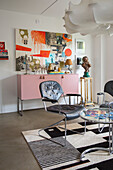 Room with modern art, vintage furniture and designer lighting