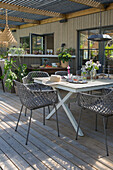Terrace design with wooden floor and modern garden furniture