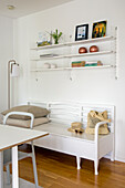 Bright room with shelves, wooden floor and white bench seat