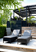 Outdoor relaxation area with sun loungers and wooden pergola
