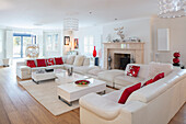 Bright living room with fireplace and white and red colour scheme