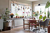 Dining room with lots of plants and large windows