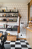 Kitchen with black and white chequered floor, wall tiles and shelving system