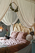Cosy bedroom with airy bed canopy