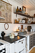 Country-style kitchen with open wooden shelves and vintage elements