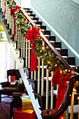 Stair railing decorated with Christmas garland