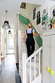 Woman climbing up white stairs