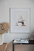 Framed wall art with letter 'A' and decorative accessories